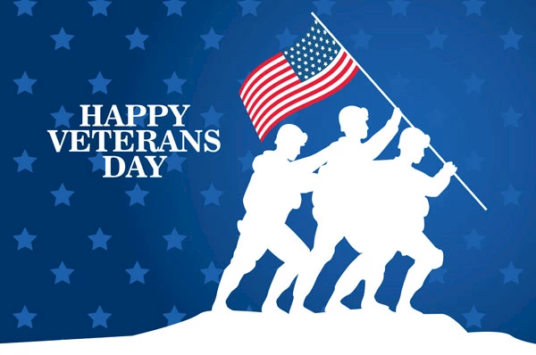 The image features a silhouette of soldiers raising an American flag with the text "HAPPY VETERANS DAY" against a blue background with stars.